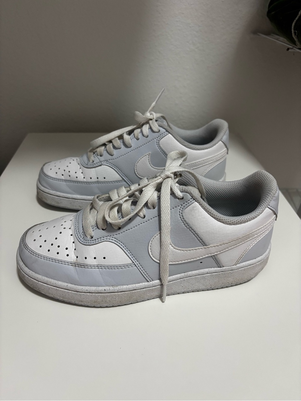 Nike White and Light Gray Low-Top Swoosh Sneakers courtesy of vision’s lows